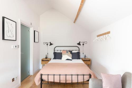 a bedroom with a bed and a couch at The Hayloft by Black Door Stays in Bath