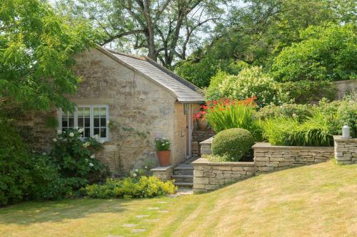 a stone house with a garden in front of it at The Hayloft by Black Door Stays in Bath
