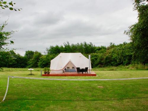 a large white tent in a grass field at Pension Lærkelill in Skovlund