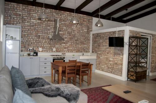 a kitchen with a table and a dining room at Alte Villa Boutique Hotel in Lüderitz