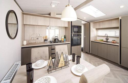 a kitchen with a table and a dining room at 1.2 padstow in Padstow