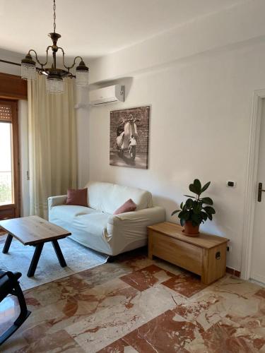 uma sala de estar com um sofá branco e uma mesa em Ciccio apartment em Bovalino Marina