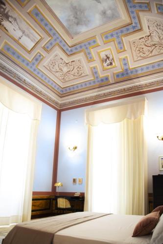 a bedroom with a coffered ceiling and a bed at Palazzo Francesco Grassi in Aradeo