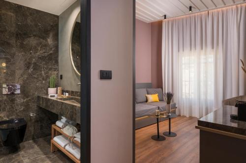 a bathroom with a vanity and a bed in a room at Veneri Boutique Suites in Chania