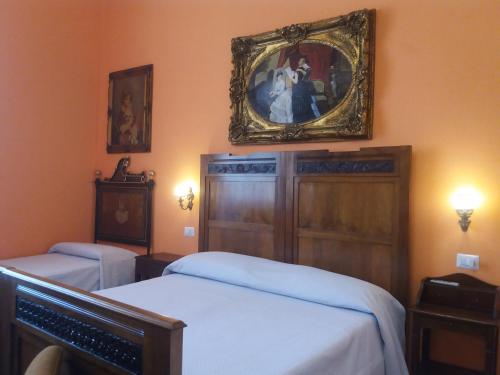 a bedroom with two beds and a mirror on the wall at Antico Palazzo Spinola in Gallipoli