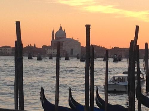 a group of gondolas in the water at sunset at Agriturismo la Chioccia in Campagna Lupia