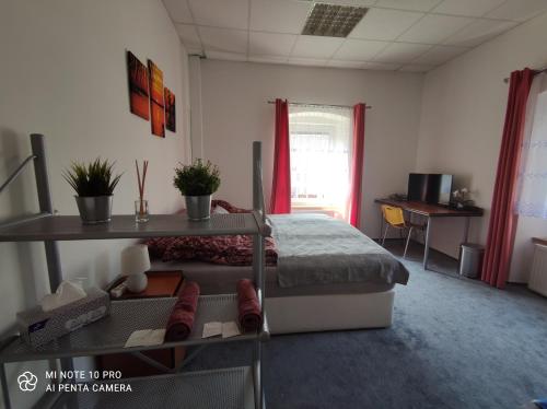 a bedroom with a bed and a table and a desk at B&B Royal Liberty in Ústí nad Labem