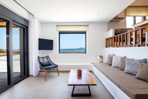 a living room with a couch and a table at Cato Agro 1, Seafront Villa with Private Pool in Karpathos Town