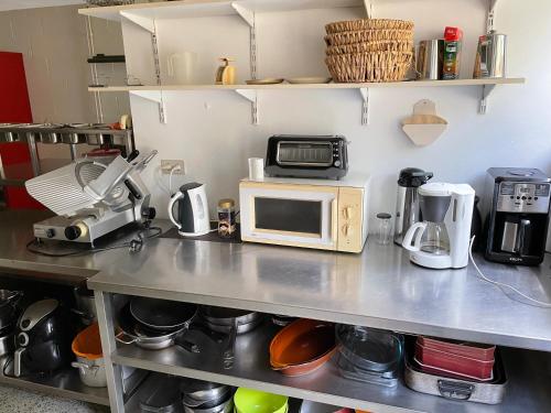 a kitchen counter with a microwave on top of it at Gîte La Semois in Chiny