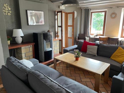 a living room with couches and a coffee table at Gîte La Semois in Chiny