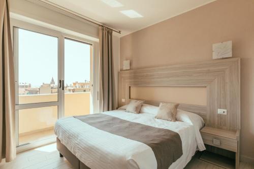 Säng eller sängar i ett rum på Hotel Residence La Palma