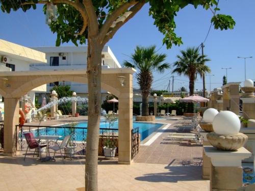 a resort with a swimming pool with chairs and trees at Antonios Hotel in Faliraki