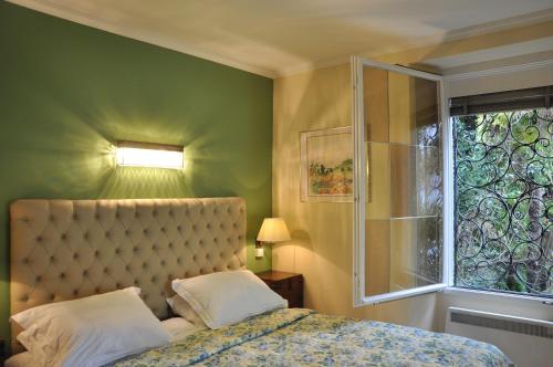 a bedroom with a bed and a window at Villa Sassalto in Lugano