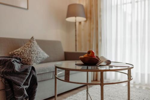 a living room with a couch and a glass table at Ferienwohnungen Johanneshof in Maria Alm am Steinernen Meer