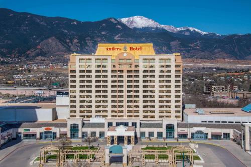 a hotel building with a mountain in the background at The Antlers, a Wyndham Hotel in Colorado Springs