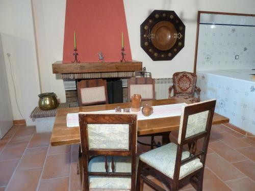 a dining room with a table and a fireplace at Aaccent Montblanc - Prenafeta in Montblanc