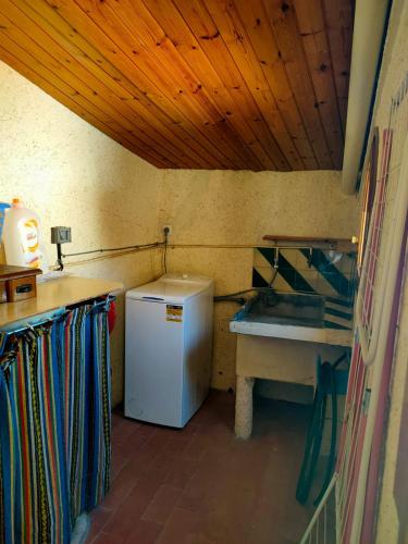 a small kitchen with a sink and a refrigerator at Ca la Magda in Camarasa