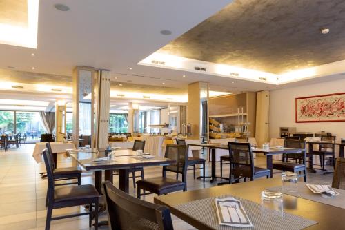 a restaurant with wooden tables and chairs and tables and chairsktop at Hotel Campagnola in Riva del Garda