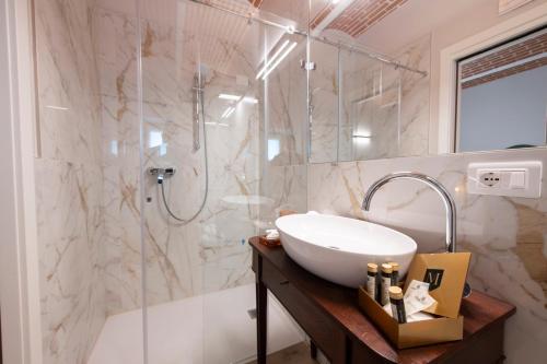 a bathroom with a sink and a shower at Magari Estates Boutique Hotel in Colognola ai Colli