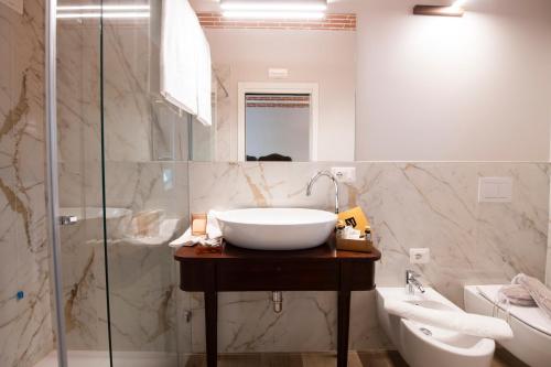 a bathroom with a white sink and a shower at Magari Estates Boutique Hotel in Colognola ai Colli