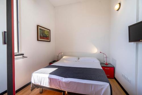 a bedroom with a bed and a flat screen tv at Hotel Cristallo in Rimini