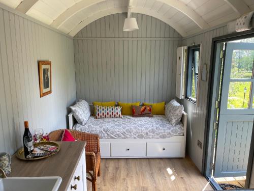 a small room with a bed in a caravan at Holly Hut Shepherds Hut in Tower Bridge