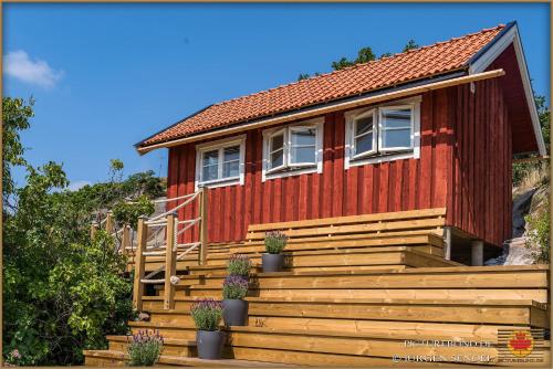 a red house with stairs leading up to it at Hem till Bengt in Kungshamn