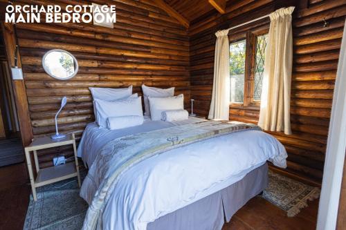 a bedroom with a large bed in a log cabin at JAYA'S PLACE in Hogsback