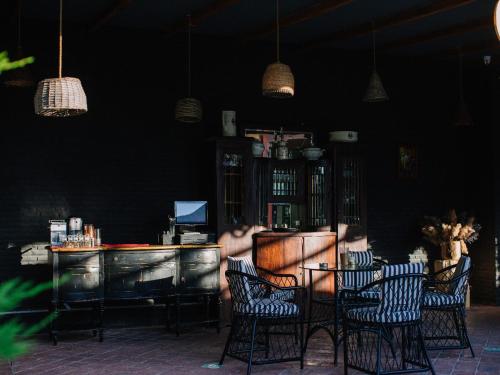 a restaurant with chairs and a bar in a room at Esquisse Design Hotel in Tʼelavi