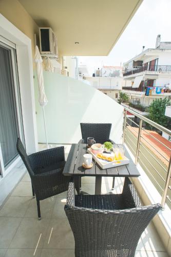 a table with a plate of food on a balcony at Lux VIP Apartments in Perea
