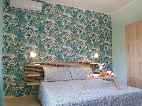 a bedroom with a bed and a green and white wallpaper at Home 123 in Pontecagnano