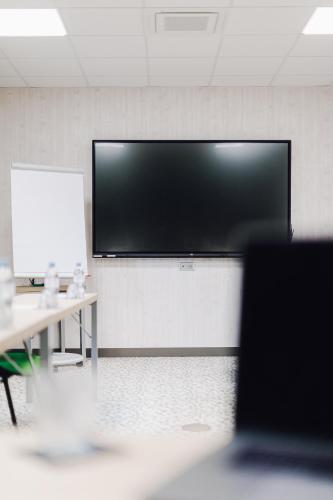 a large flat screen tv on a wall in a room at ibis Styles Contres-Cheverny in Le Controis En Sologne