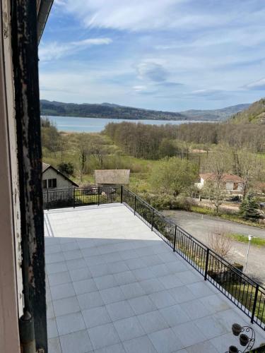a balcony with a view of a lake at Beau séjour in Aiguebelette-le-Lac