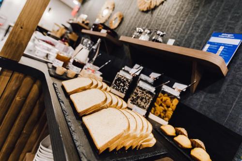a buffet with bread and other food on a table at ibis Styles Contres-Cheverny in Le Controis En Sologne