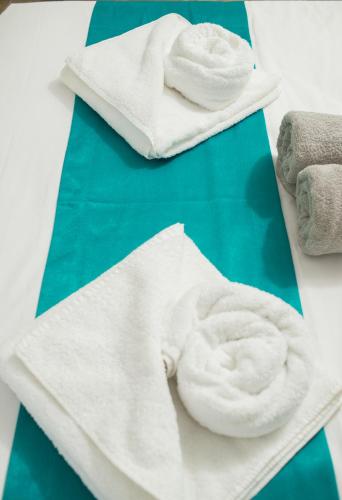 two white towels sitting on top of a table at Lux VIP Apartments in Perea
