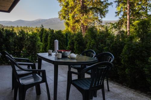 a table and chairs on a patio with a view at Apartamentowiec Panorama Gór City Center Family&Pet-friendly in Szklarska Poręba
