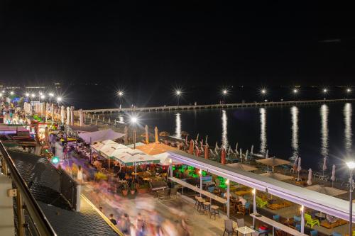 a view of a pier at night with lights at Lux VIP Apartments in Perea