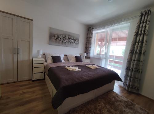 a bedroom with a large bed and a window at Penzion Wellness Chechluvka in Dolní Tošanovice