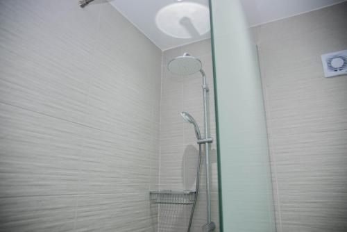a shower with a glass door in a bathroom at Amazing Maisonette next to harbour of Paphos CY in Paphos