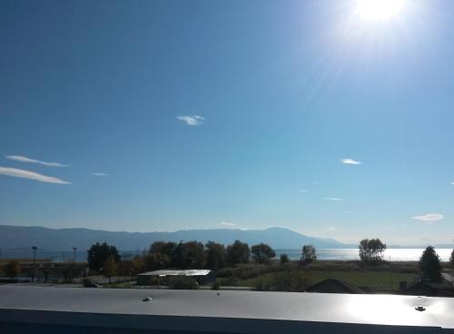 a view of the water and mountains from a roof at Marko Apartments in Struga