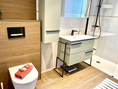 a bathroom with a toilet and a sink and a shower at VUE DES ANGES AP4238 By Riviera Holiday Homes in Nice
