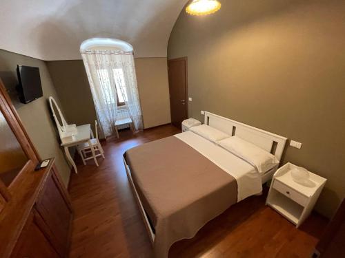 a bedroom with a bed and a table and a window at B&B La Casetta in Villa Santa Maria