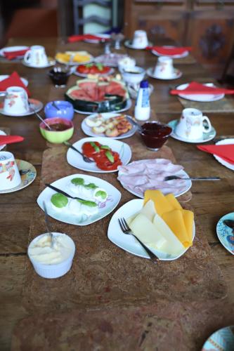 a table topped with plates of food on top of a wooden table at Casa Grande Portugal in Burgau
