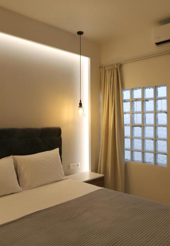 a bedroom with a bed and a window at S & D Apartment in Sitia