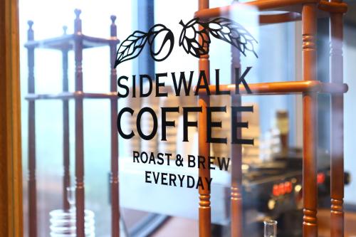 a sign in a window of a coffee shop at MUSTARD HOTEL SHIMOKITAZAWA in Tokyo