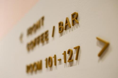 a clock with the word alarm on a wall at MUSTARD HOTEL SHIMOKITAZAWA in Tokyo