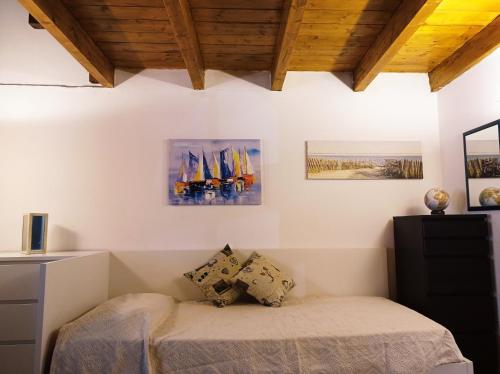 a bedroom with a bed in a room with wooden ceilings at Casa Peppy in Palermo