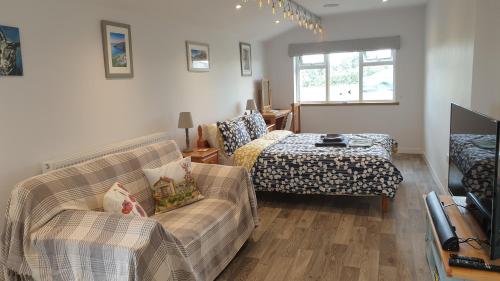 a living room with a couch and a bed at The Nook B&B in Port Isaac