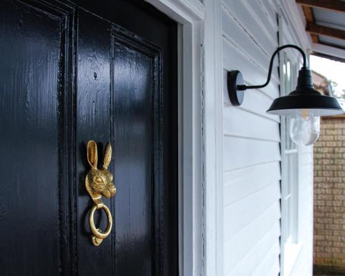a door with a gold bunny door knocker on it at Alexander Cottage Daylesford in Daylesford