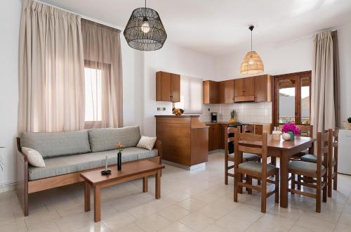 a living room and kitchen with a couch and a table at Artemis Apartments in Stalos